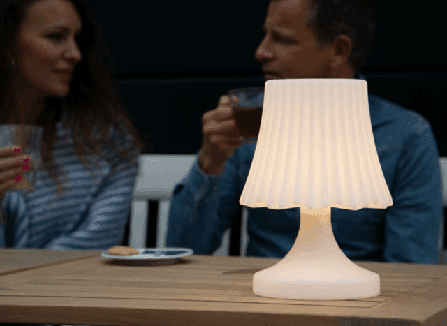 a cosy little table lamp with multicoloured lighting and a speaker on the terrace